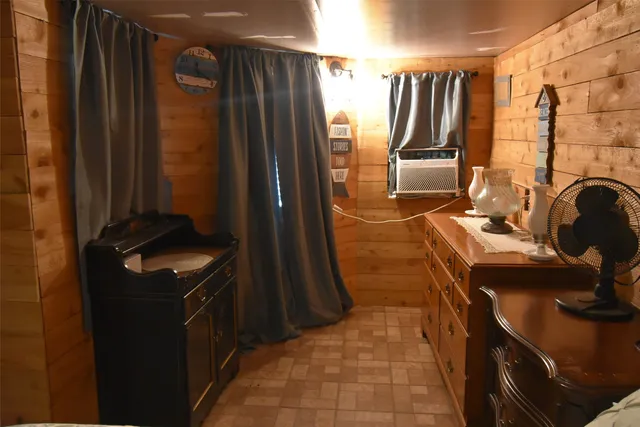 a room with granite countertop lots of clutter and washer