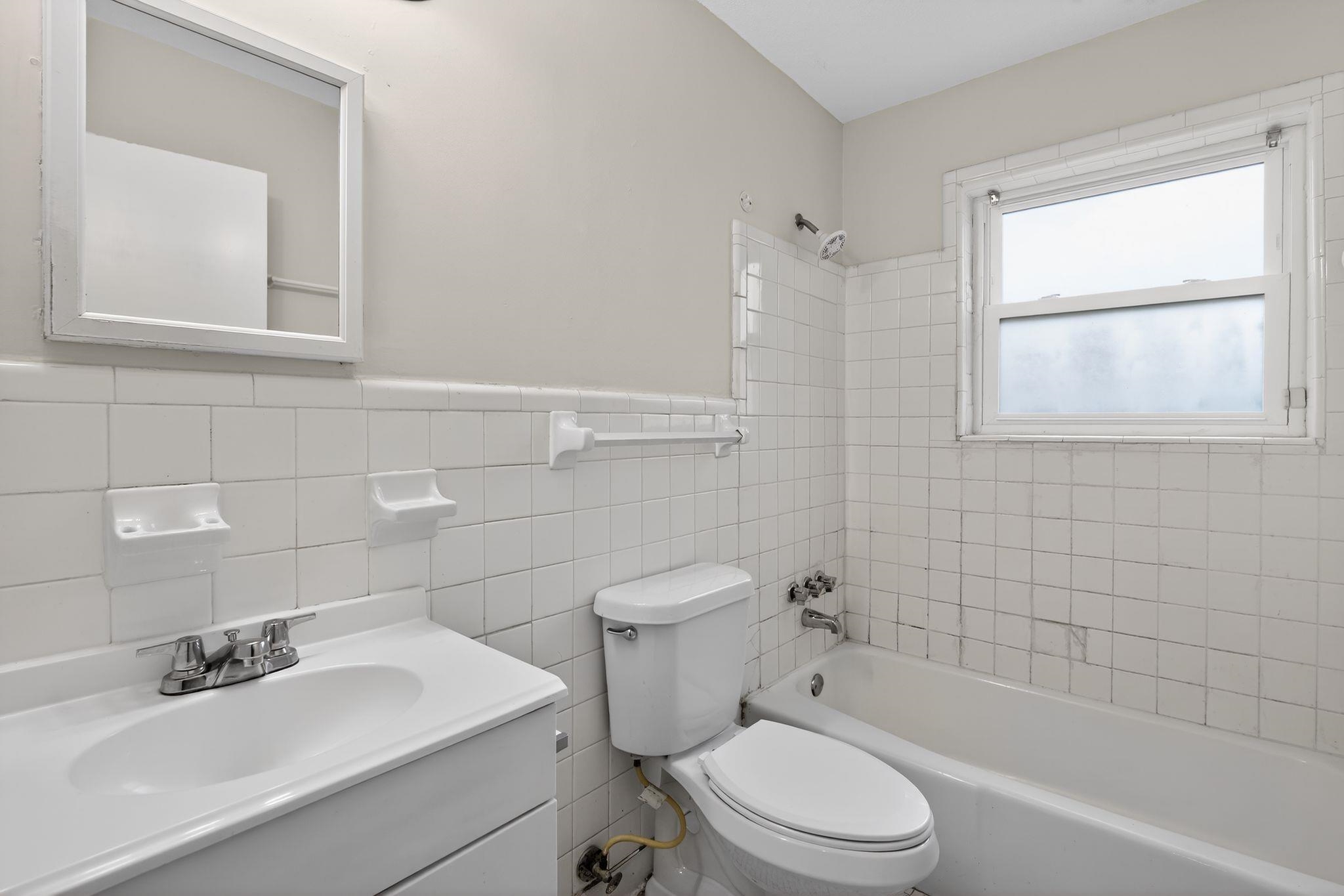 3741 Ridgemont Road Memphis, TN 38128 - Photo 30 of 32 Full bathroom featuring vanity, shower / tub combination, tile walls, and wainscoting