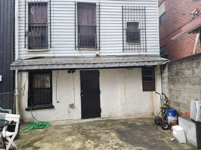 a view of a house with wooden door and stairs