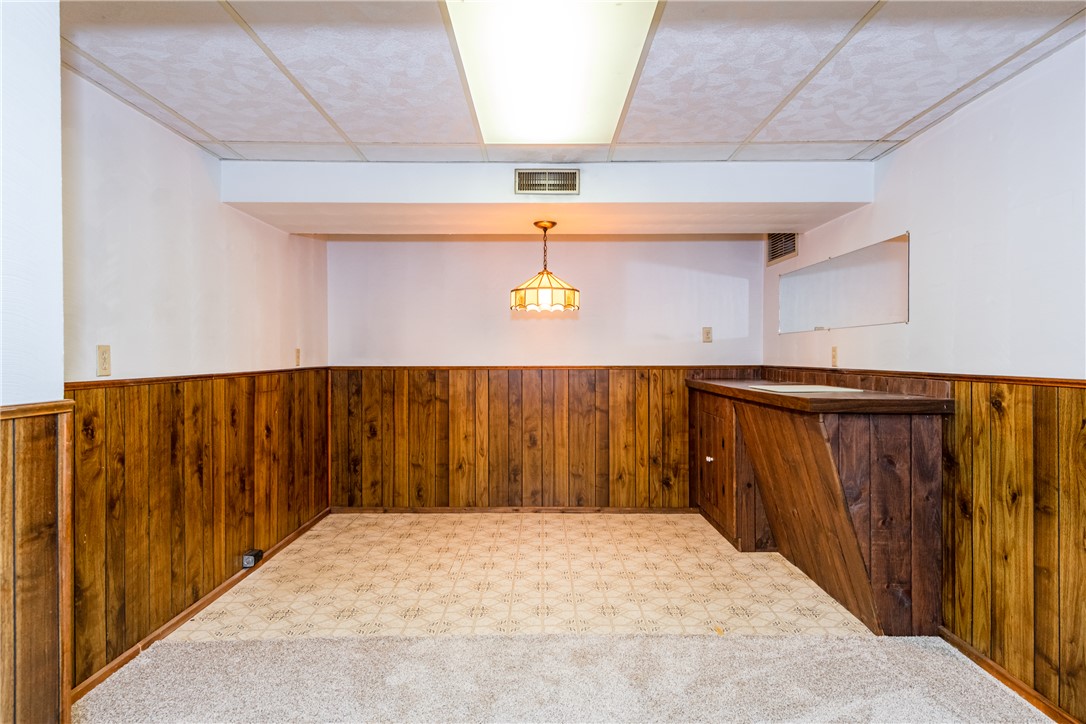 1176 Geneva Road Dayton, OH 45434 - Photo 26 of 55 This versatile basement space features charming wood paneling, offering potential for recreation or game room