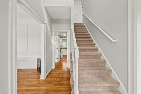 a kitchen with granite countertop a sink cabinets and wooden floor