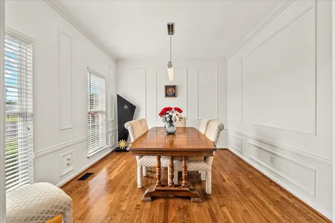 a kitchen with granite countertop white cabinets and window