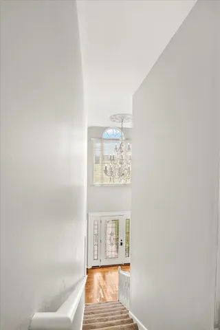 a view of a bedroom with large bed and large windows