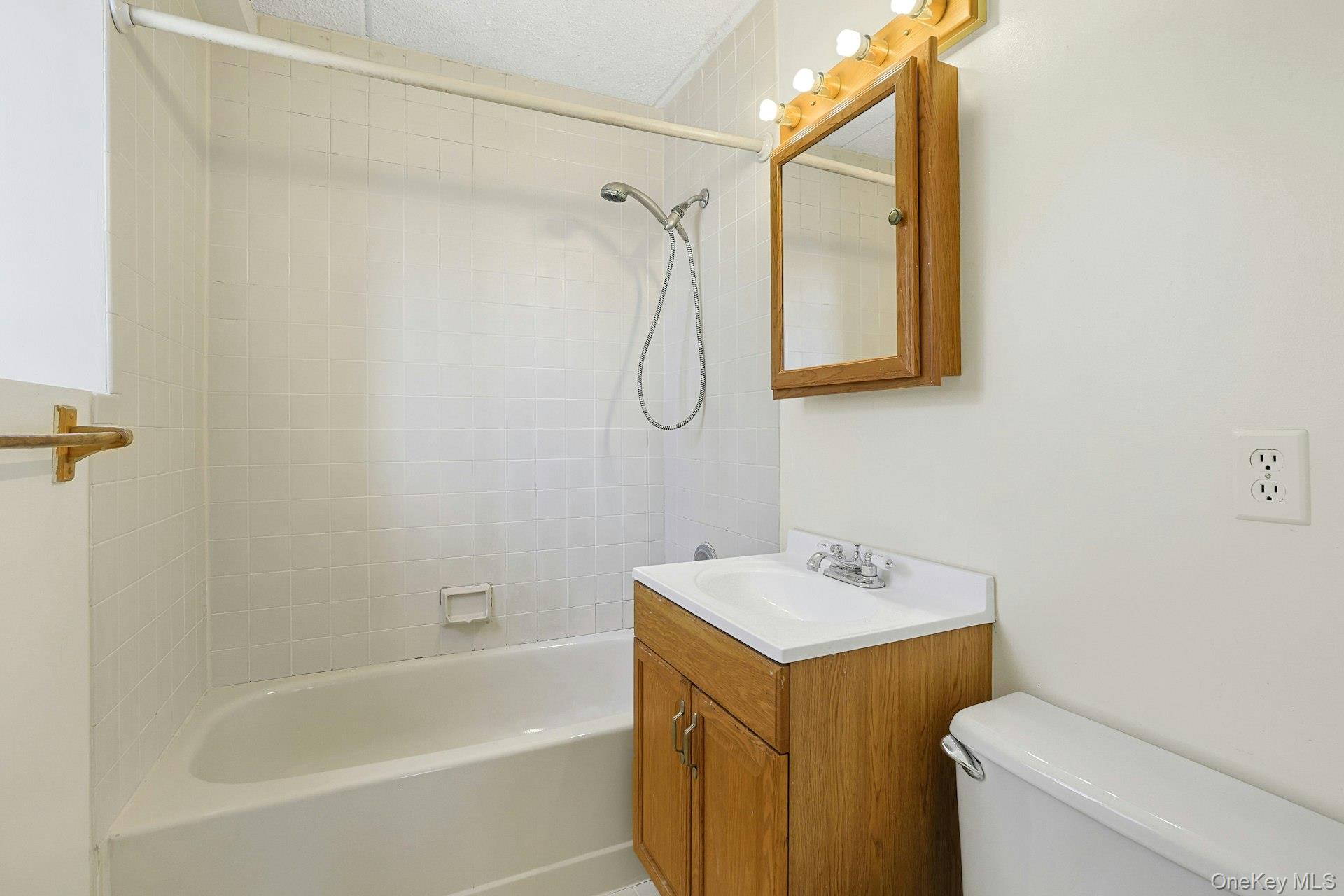 560 Halstead Avenue, Unit 2E Harrison, NY 10528 - Photo 21 of 28 a bathroom with a shower a sink and a toilet