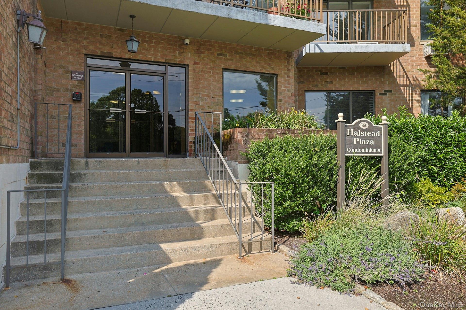 560 Halstead Avenue, Unit 2E Harrison, NY 10528 - Photo 27 of 28 a view of a building with potted plants