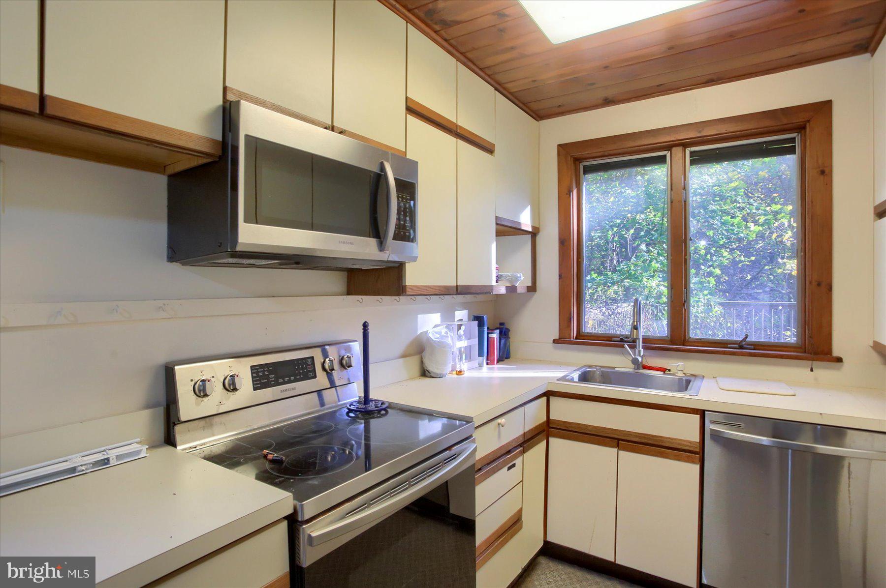1025 Roberts Valley Road Harrisburg, PA 17110 - Photo 14 of 38 a kitchen with a stove a sink and a microwave
