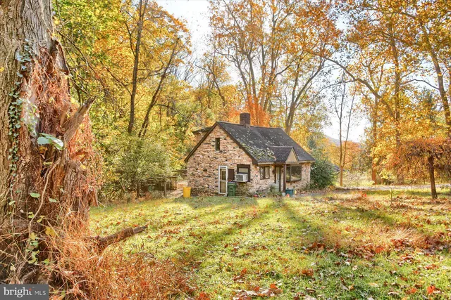 a house with tall trees in front of it