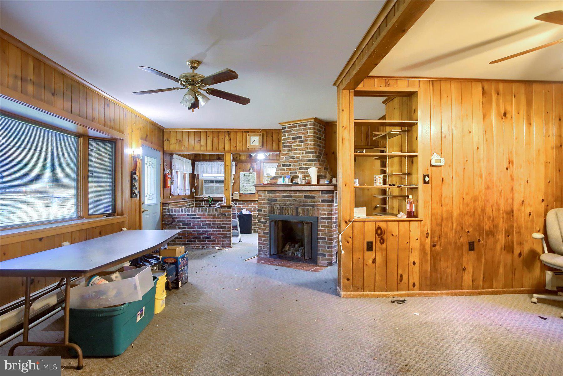 1025 Roberts Valley Road Harrisburg, PA 17110 - Photo 10 of 38 a living room with a table chairs and a refrigerator