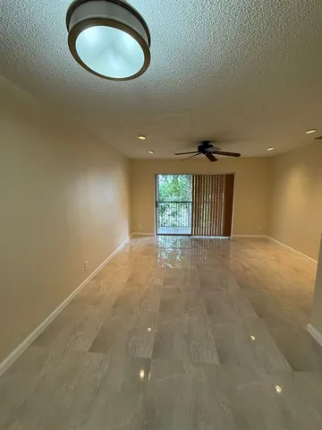 an empty room with a empty space and windows