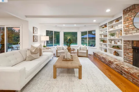 a living room with furniture and a floor to ceiling window