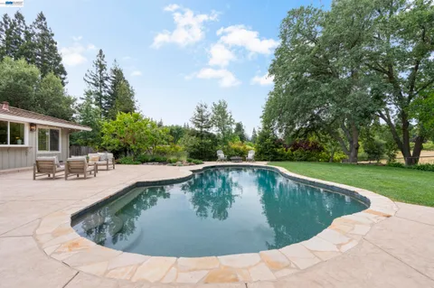 a front view of house with yard and outdoor seating