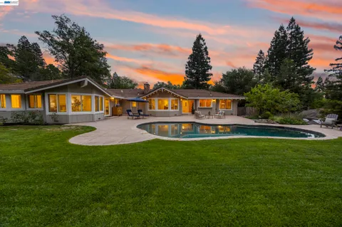 a view of a swimming pool with an outdoor space and seating area
