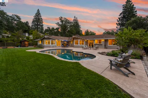 a view of a house with swimming pool yard and outdoor seating