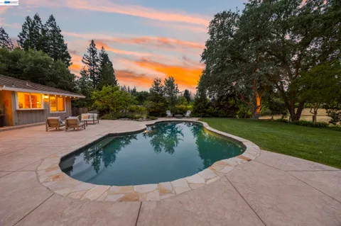 a view of a swimming pool with a patio