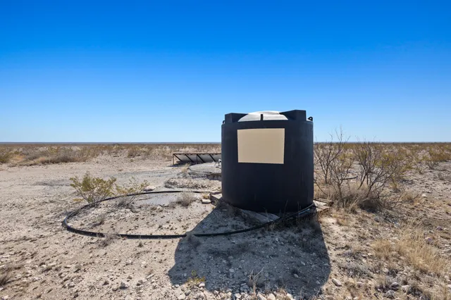 a view of a ocean next to a yard