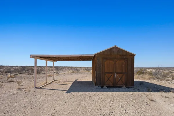 a view of a dry yard with a house