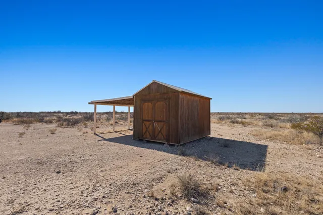 a wooden bench sitting in the middle of a beach