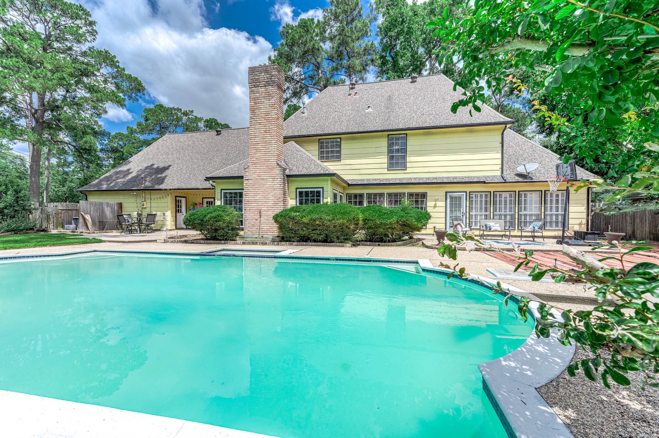9911 Oxted Lane Spring, TX 77379 - Photo 1 of 39 a front view of a house with swimming pool having outdoor seating