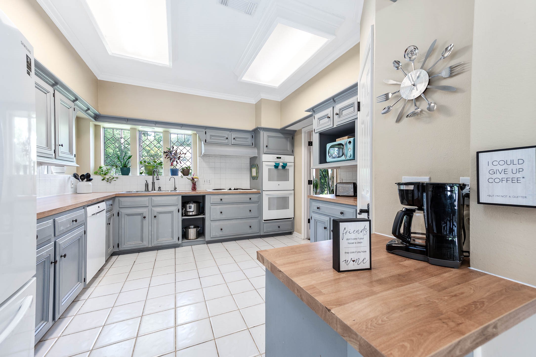 9911 Oxted Lane Spring, TX 77379 - Photo 12 of 39 a kitchen with stainless steel appliances granite countertop a sink and cabinets