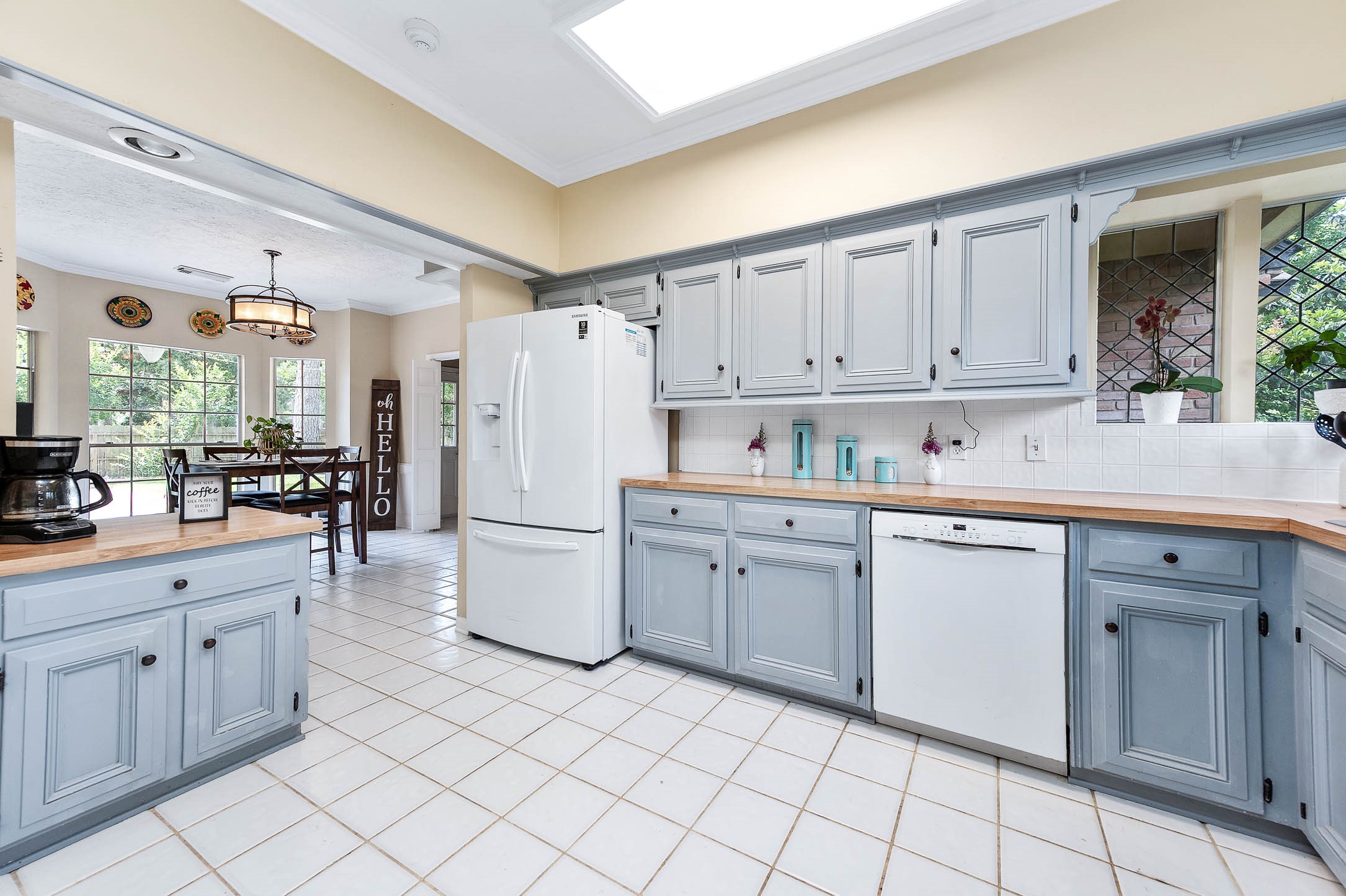 9911 Oxted Lane Spring, TX 77379 - Photo 14 of 39 a kitchen with cabinets and white appliances