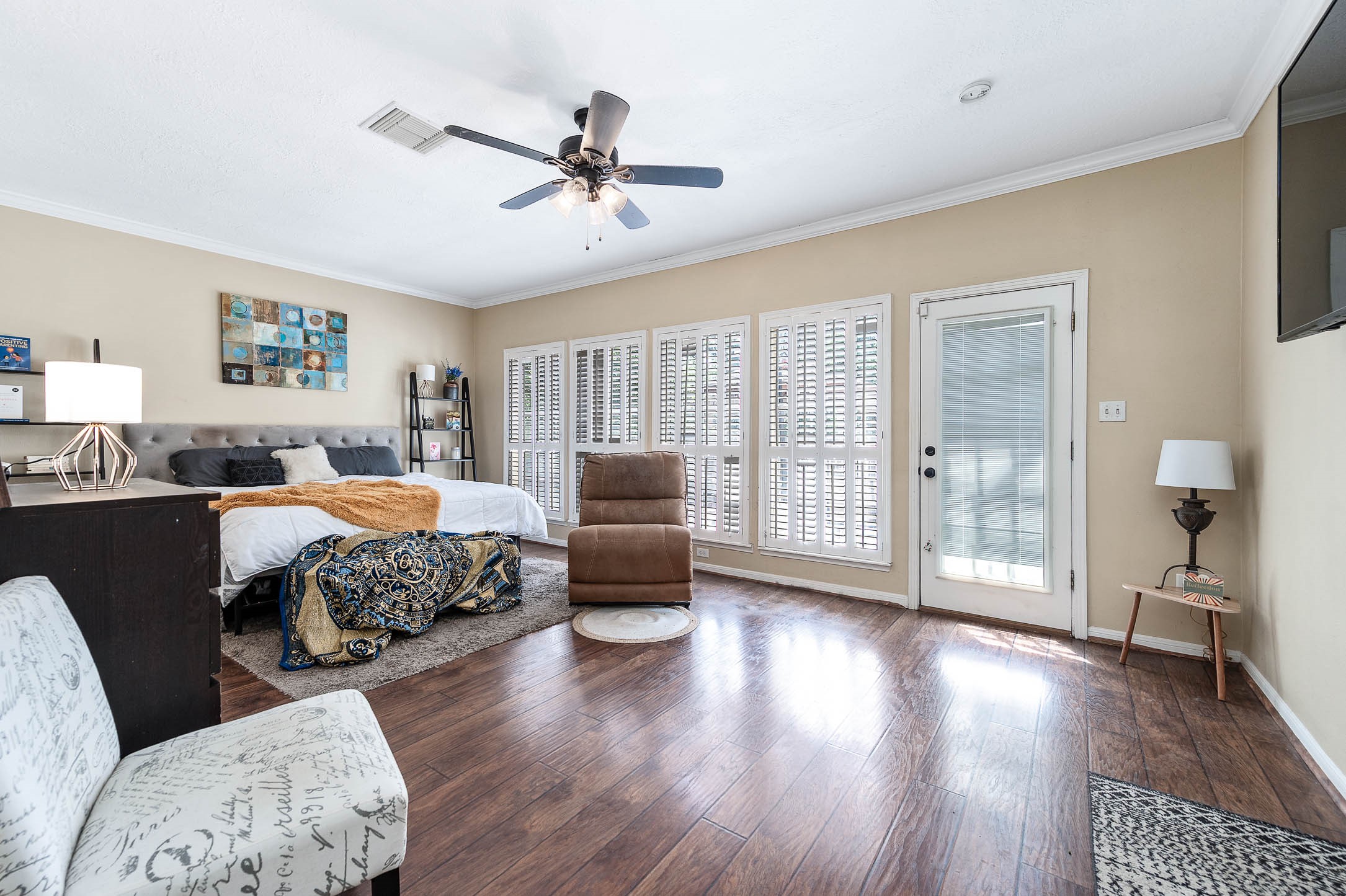 9911 Oxted Lane Spring, TX 77379 - Photo 18 of 39 a bedroom with a large bed and a chandelier