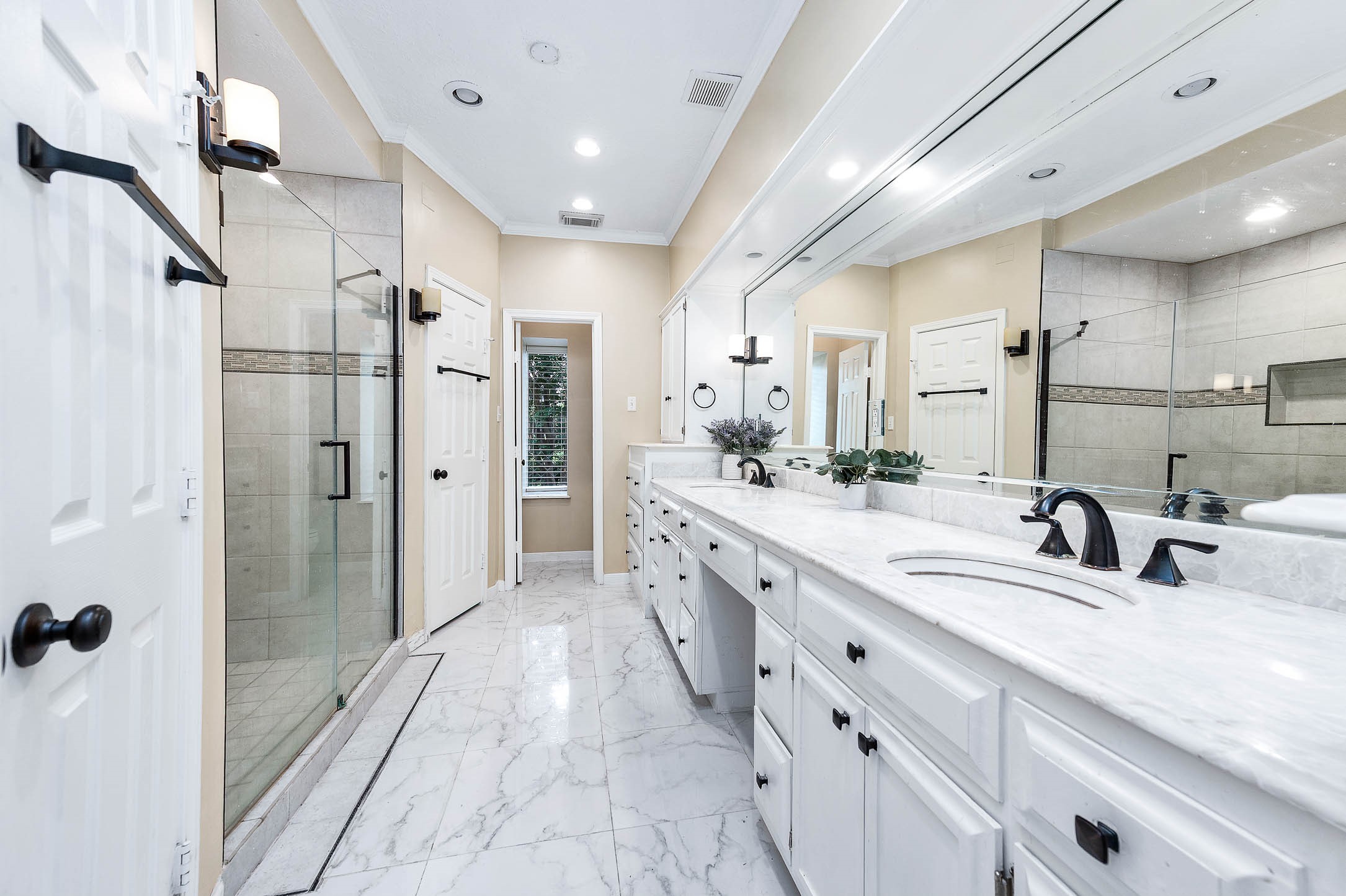 9911 Oxted Lane Spring, TX 77379 - Photo 19 of 39 a spacious bathroom with a double vanity sink mirror double and shower