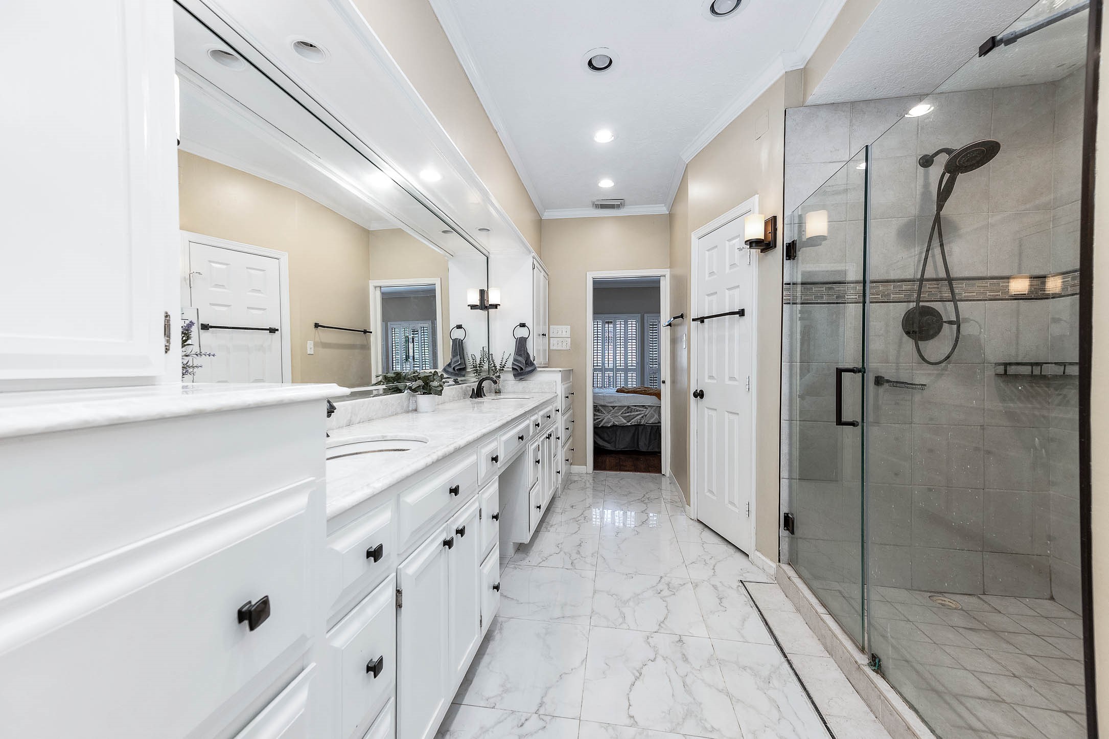 9911 Oxted Lane Spring, TX 77379 - Photo 21 of 39 a bathroom with a double vanity sink mirror and shower