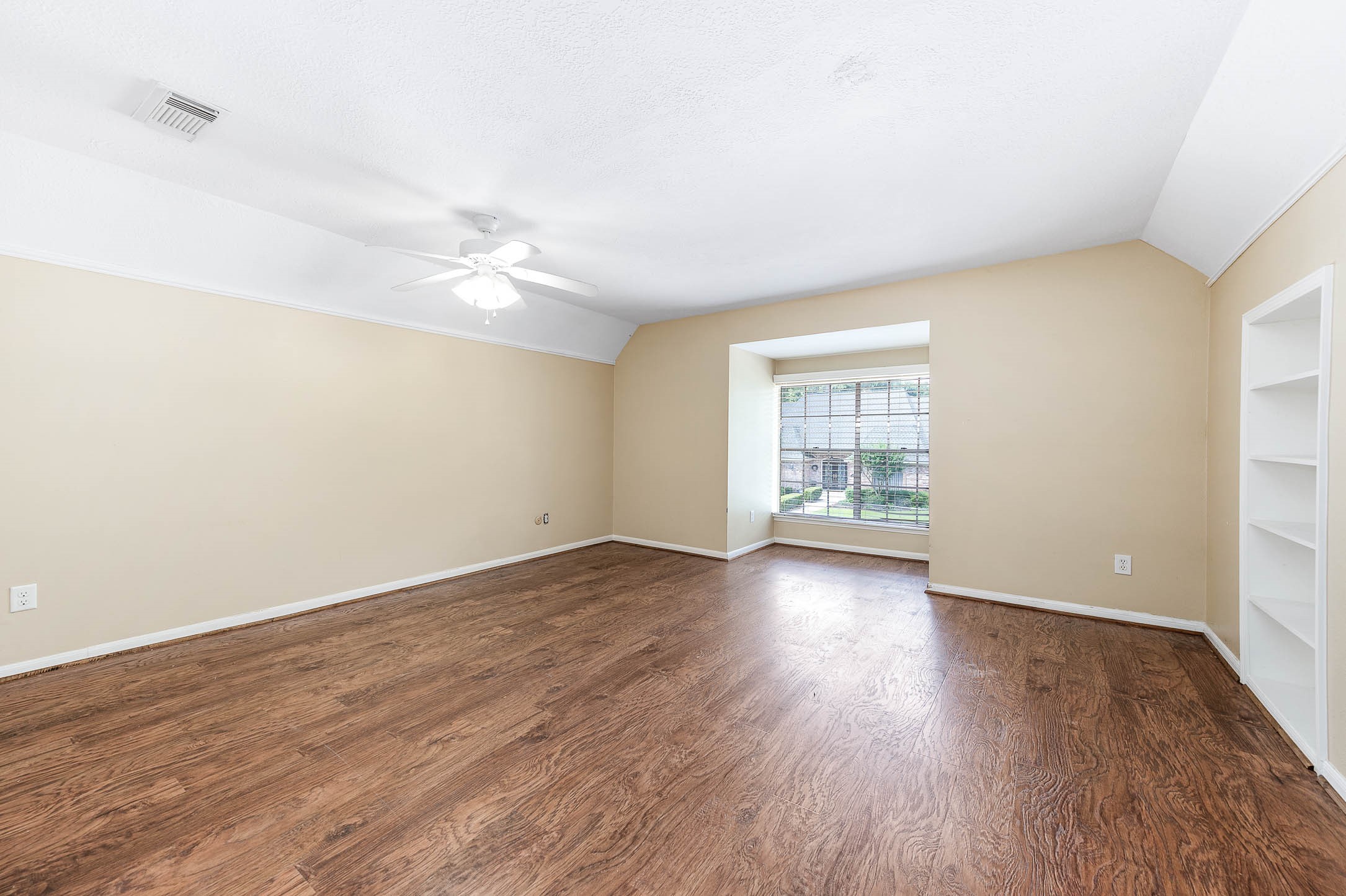 9911 Oxted Lane Spring, TX 77379 - Photo 22 of 39 an empty room with wooden floor and windows