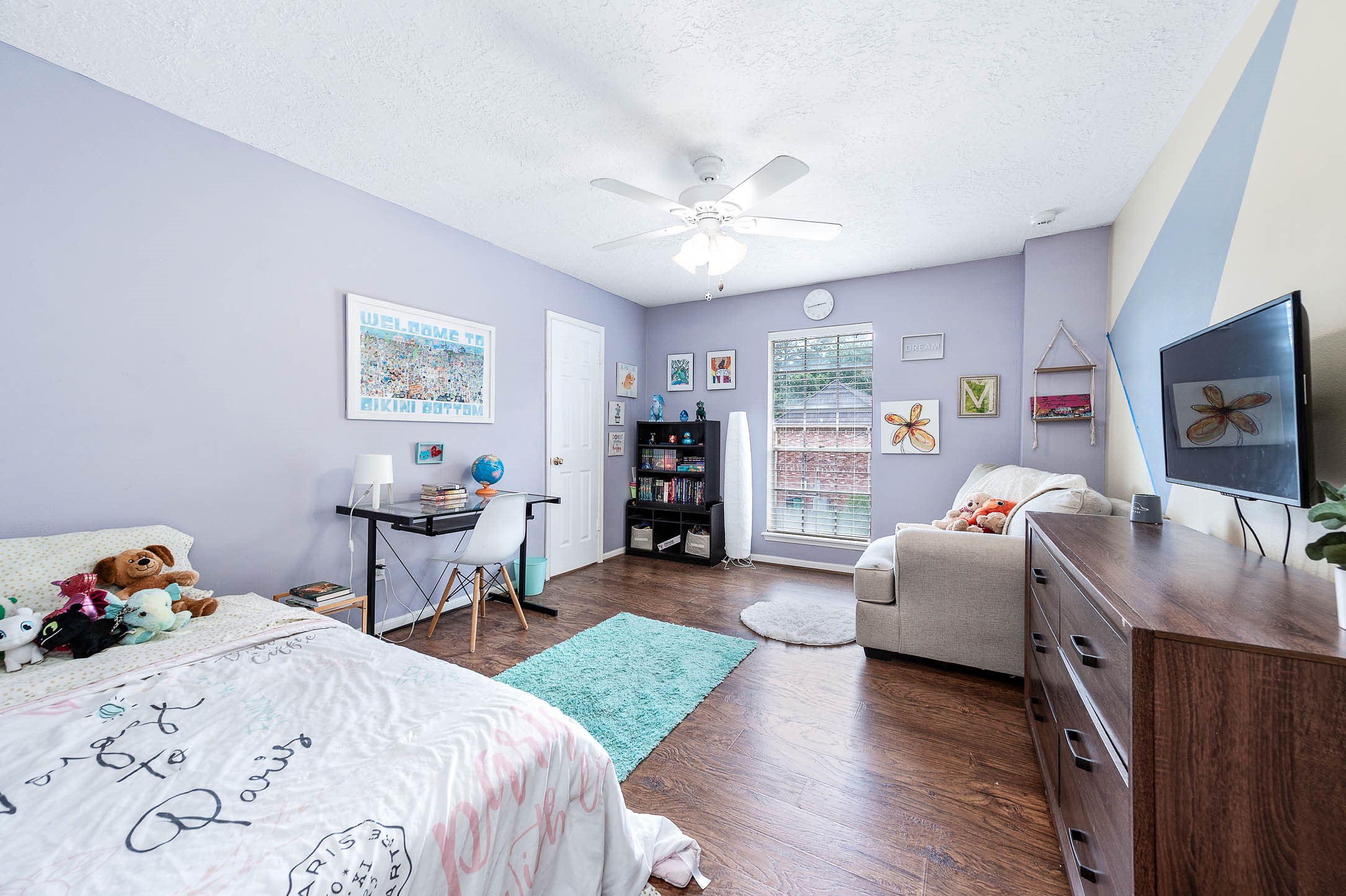 9911 Oxted Lane Spring, TX 77379 - Photo 25 of 39 a bedroom with furniture and a flat screen tv