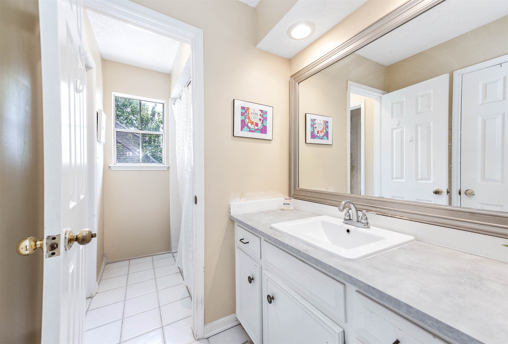 9911 Oxted Lane Spring, TX 77379 - Photo 26 of 39 a bathroom with a sink and a mirror
