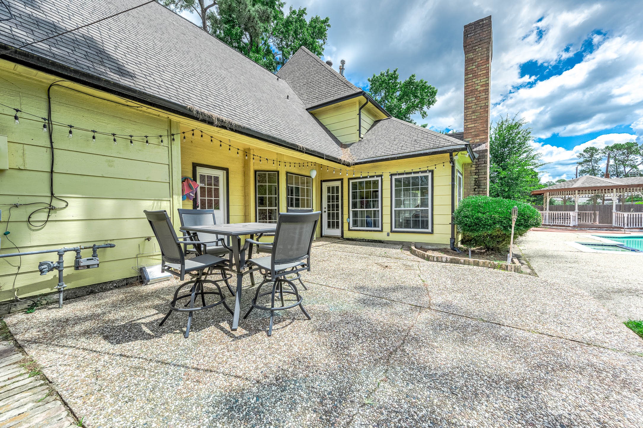 9911 Oxted Lane Spring, TX 77379 - Photo 30 of 39 a view of a patio with table and chairs and potted plants