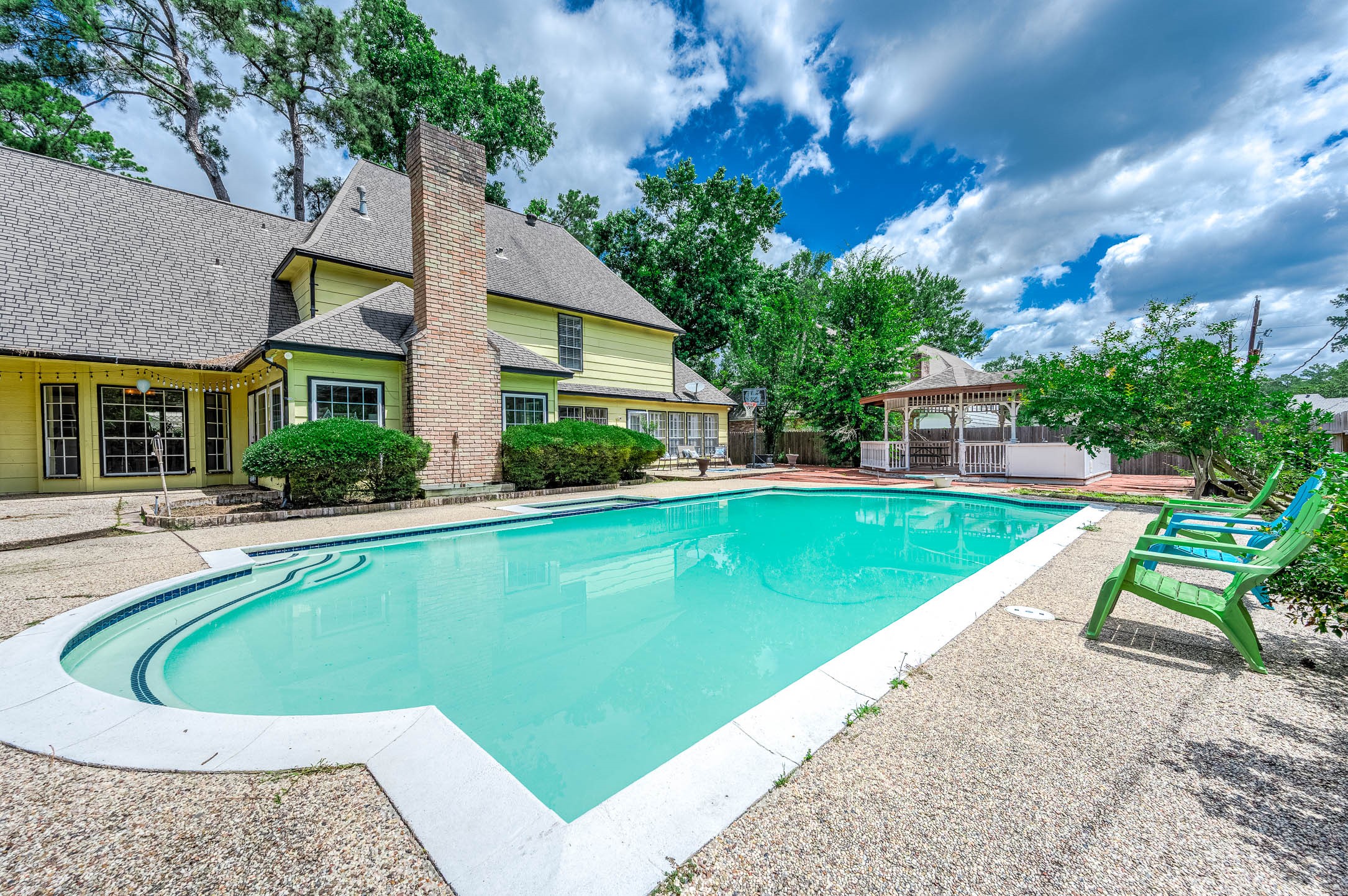 9911 Oxted Lane Spring, TX 77379 - Photo 33 of 39 a view of a house with a swimming pool