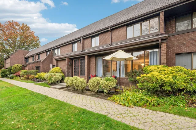 a front view of a house with garden and porch