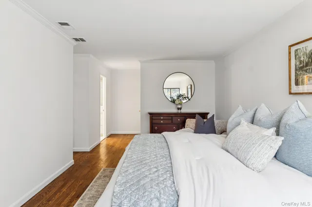 a bed room with a bed mirror and a window
