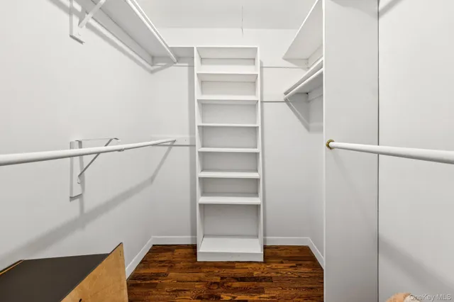 a view of walk in closet with empty racks
