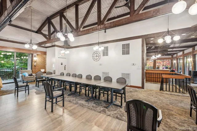 a dining room with furniture window and wooden floor
