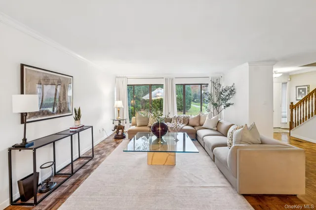 a living room with furniture and a table with wooden floor