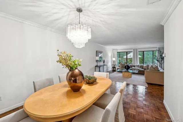 a view of a dining room with furniture wooden floor and chandelier