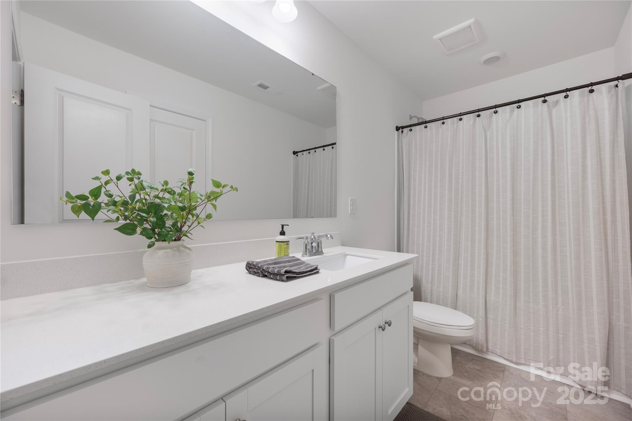 699 Kitfox Drive Northwest Concord, NC 28027 - Photo 24 of 33 a bathroom with a sink a toilet and a mirror