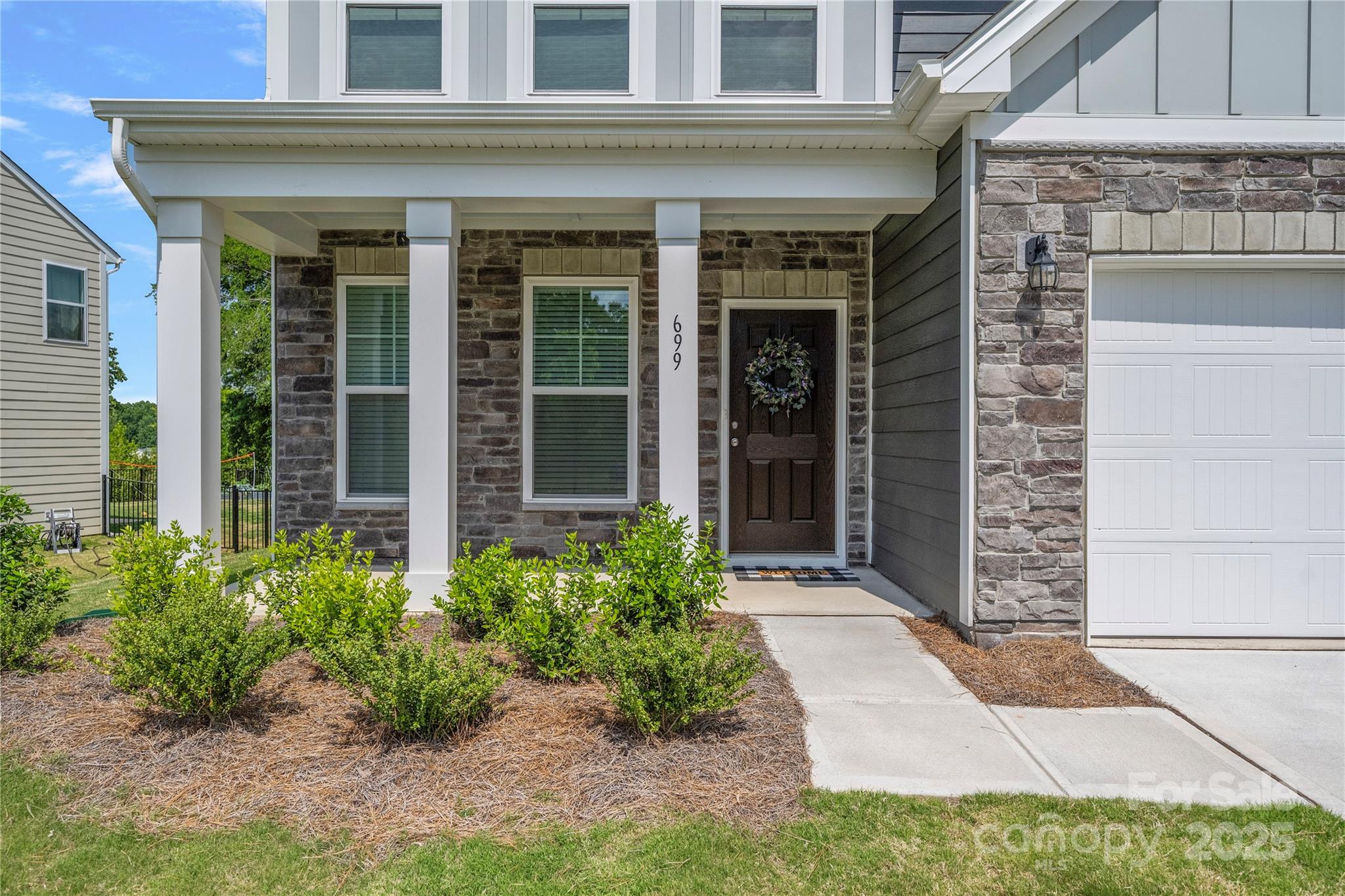 699 Kitfox Drive Northwest Concord, NC 28027 - Photo 3 of 33 front view of a brick house with a yard