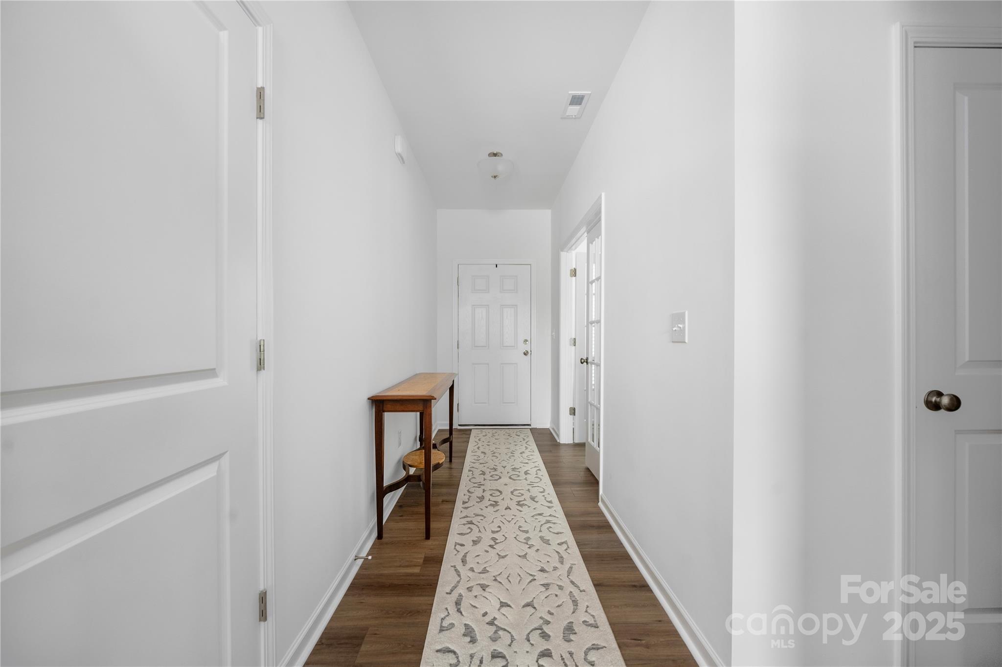 699 Kitfox Drive Northwest Concord, NC 28027 - Photo 4 of 33 a view of a hallway with wooden floor and staircase