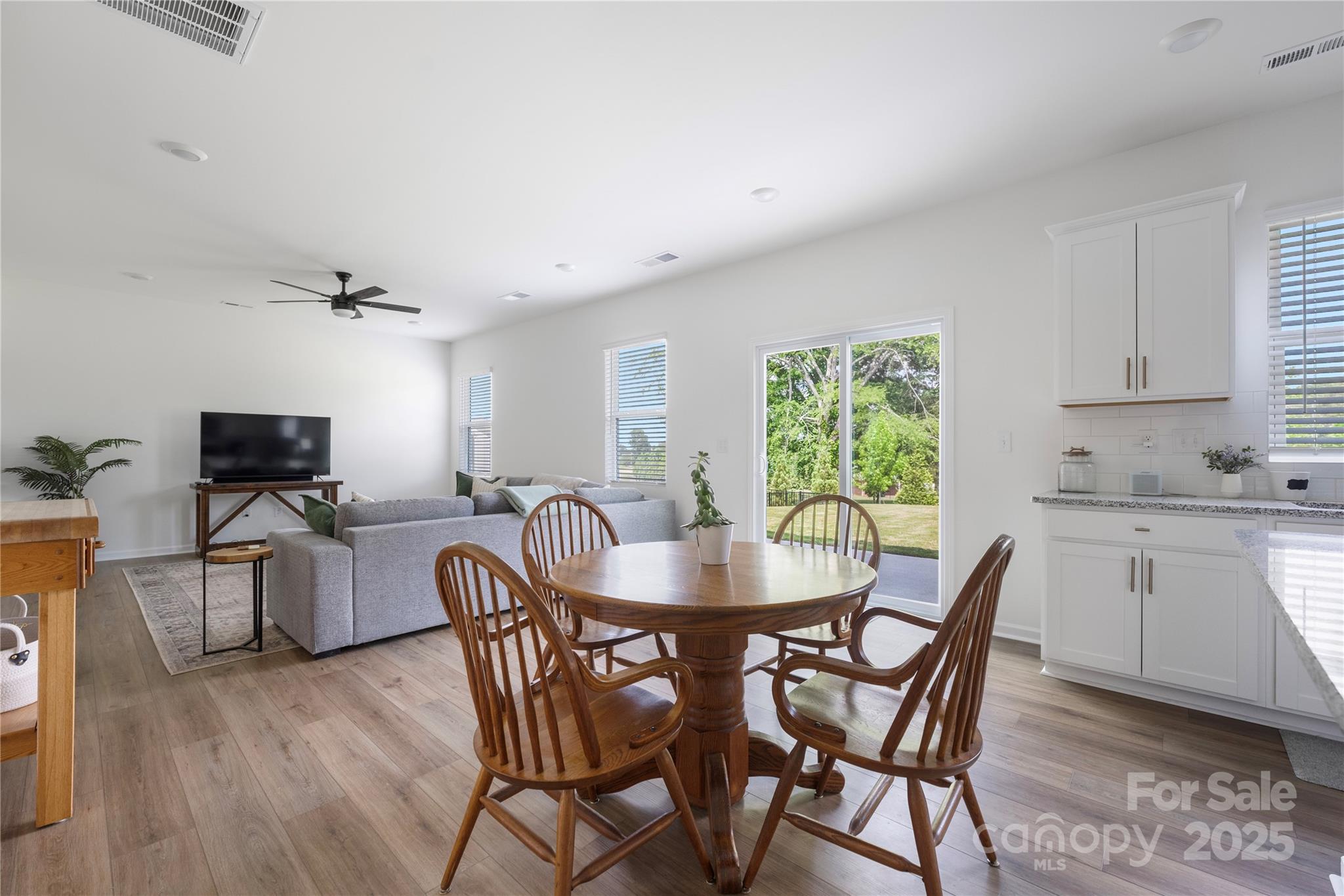 699 Kitfox Drive Northwest Concord, NC 28027 - Photo 10 of 33 a dining room with furniture a window and appliances