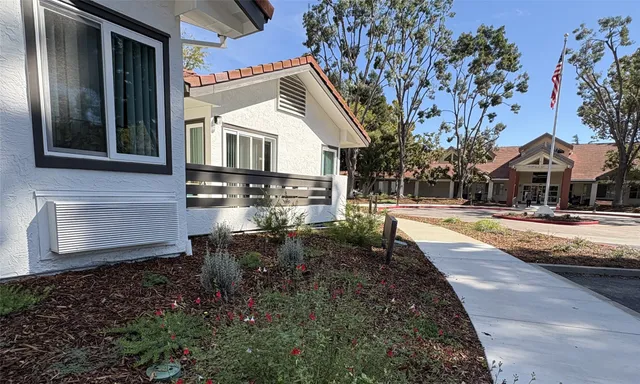 a view of a house with backyard and sitting area