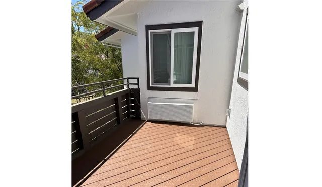 a view of a balcony with wooden floor