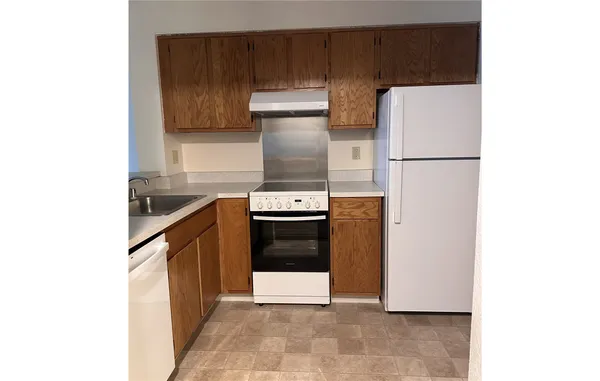 a kitchen with a refrigerator and a stove