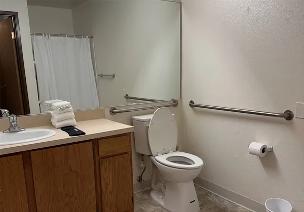 a bathroom with a sink toilet and a mirror