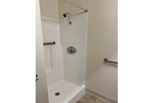 a bathroom with a glass shower door