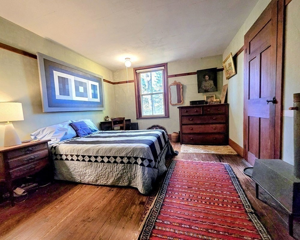 78 Shaker Road Harvard, MA 01451 - Photo 23 of 42 a spacious bedroom with a bed and a dresser in it