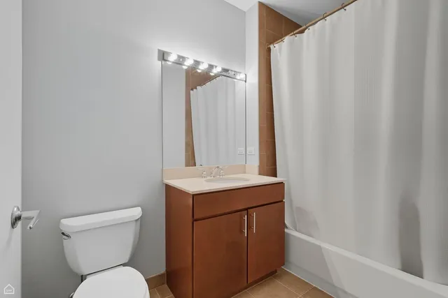 a bathroom with a toilet a sink and a shower