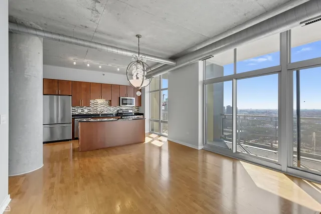 a view of kitchen with refrigerator and window